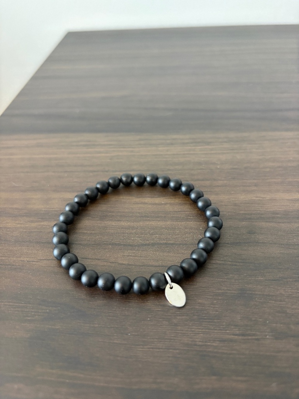 2/$20 Tocara matte black bead bracelet with a oval charm